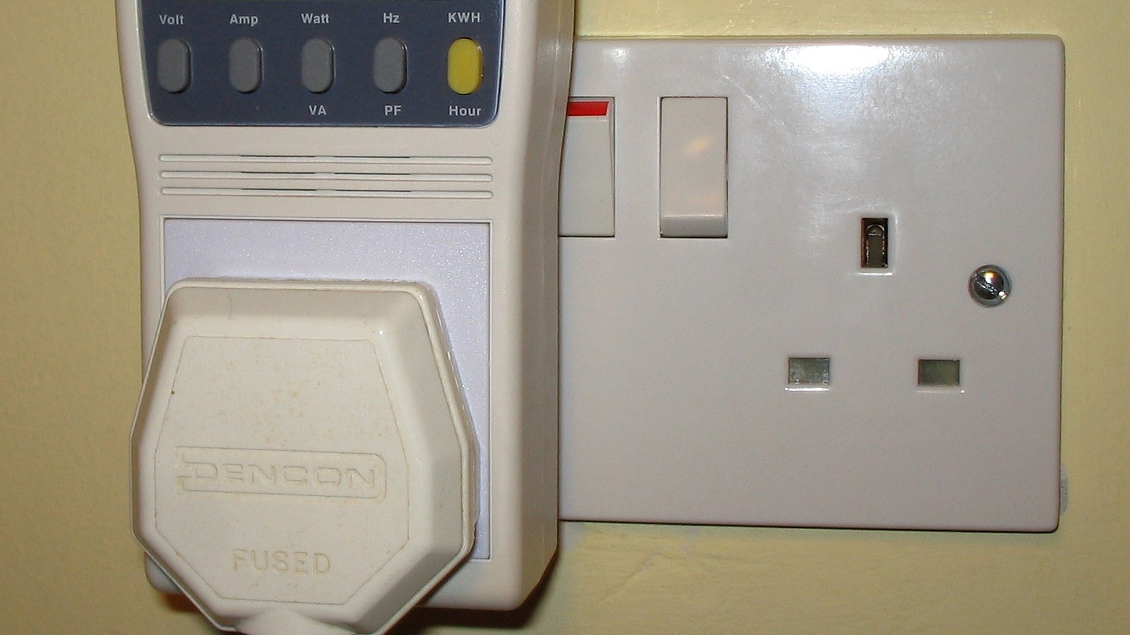 Real photo of plug-in power and energy monitor in uk domestic mains socket for How to compare running cost claims on product pages