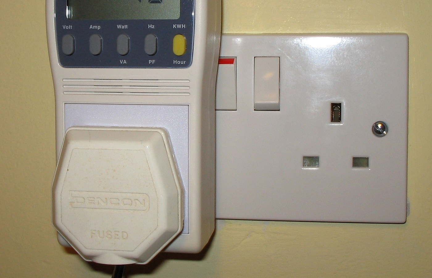 Real photo of plug-in power and energy monitor in uk domestic mains socket for How to compare running cost claims on product pages