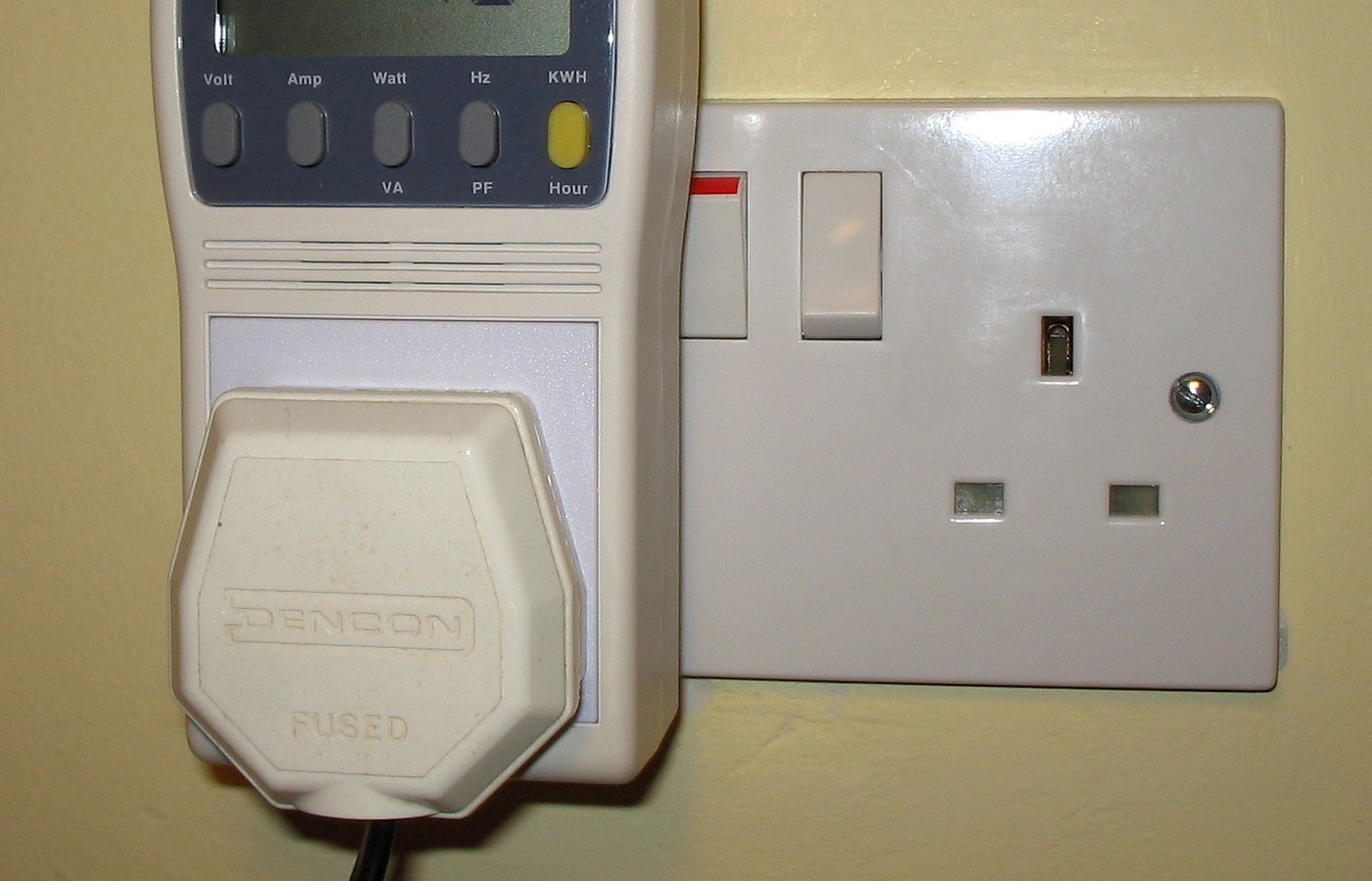 Real photo of plug-in power and energy monitor in uk domestic mains socket for How to read a plug monitor without overreacting to one number